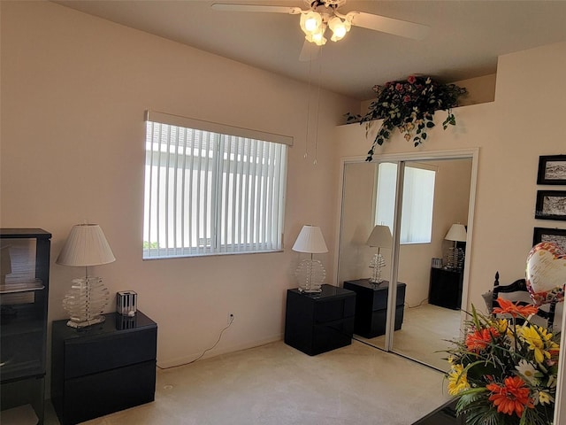 interior space with light carpet and ceiling fan