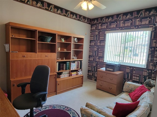 carpeted office space featuring ceiling fan