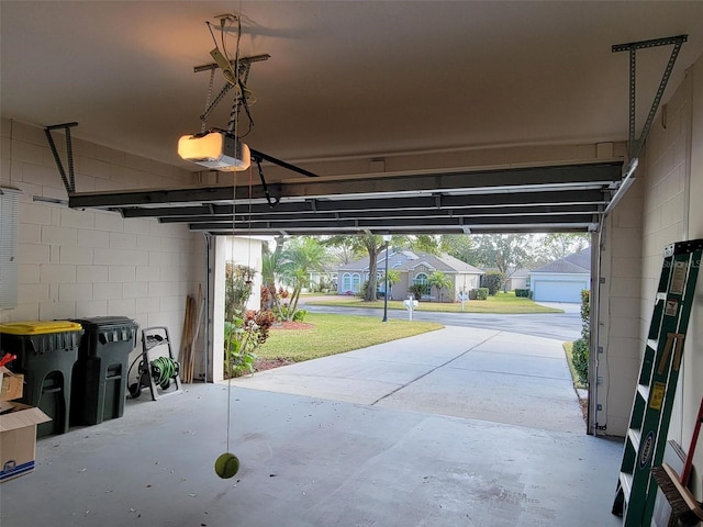 garage featuring a garage door opener and a lawn