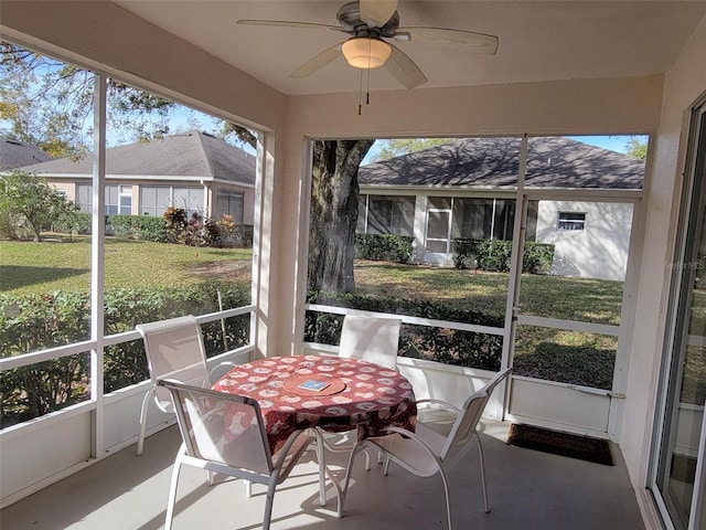 sunroom / solarium featuring ceiling fan