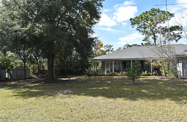 view of yard with a storage unit and covered porch