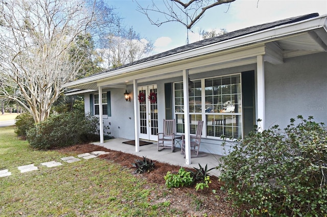 exterior space featuring a yard and french doors