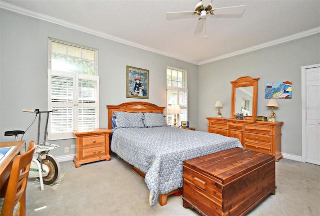 bedroom featuring crown molding, ceiling fan, and light colored carpet