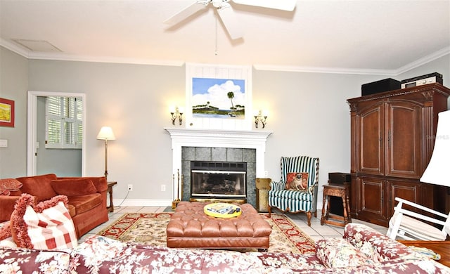 tiled living room with a tile fireplace, ornamental molding, and ceiling fan