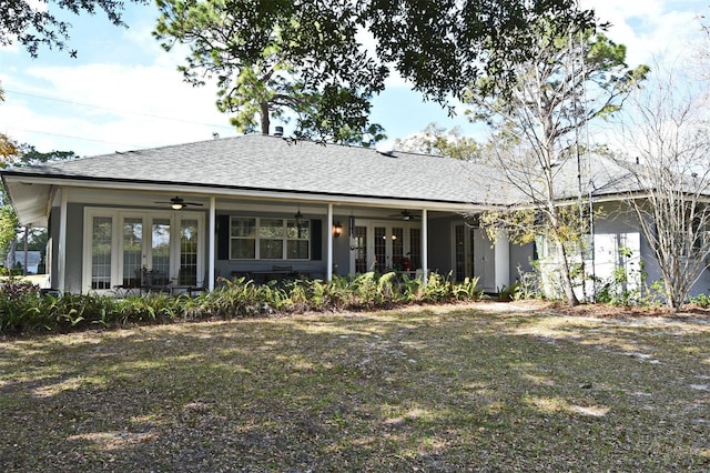 view of front of property featuring a front lawn, ceiling fan, and french doors