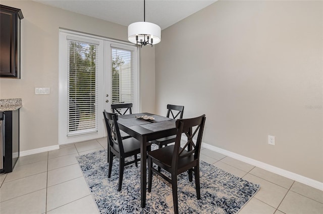 tiled dining space featuring a notable chandelier