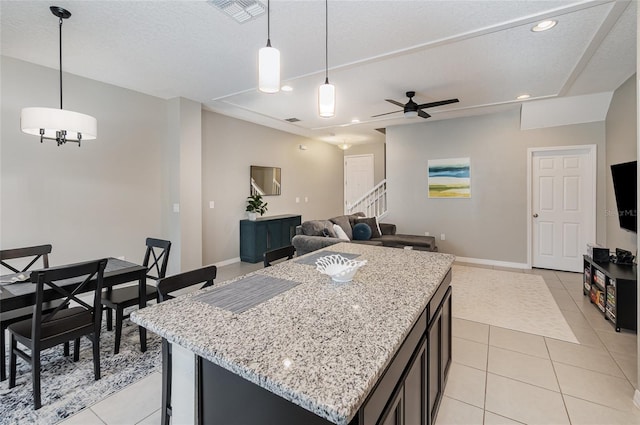 kitchen with a center island, pendant lighting, and light tile patterned floors