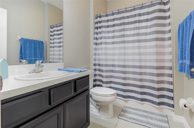 bathroom featuring vanity, tile patterned floors, and toilet