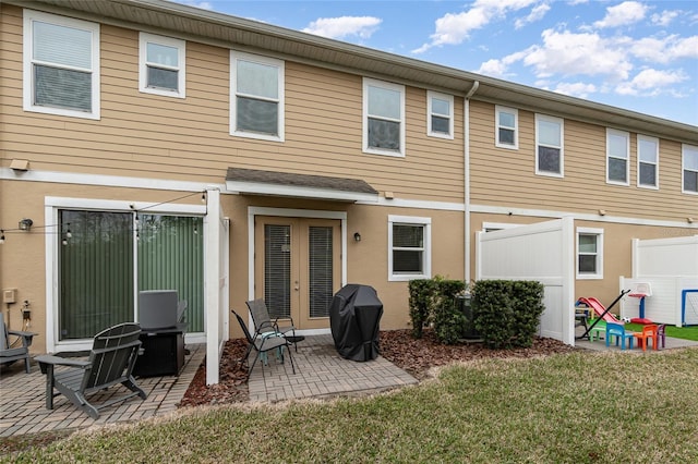 back of house with a patio and a yard