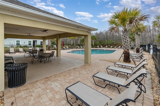 view of swimming pool featuring a patio and ceiling fan