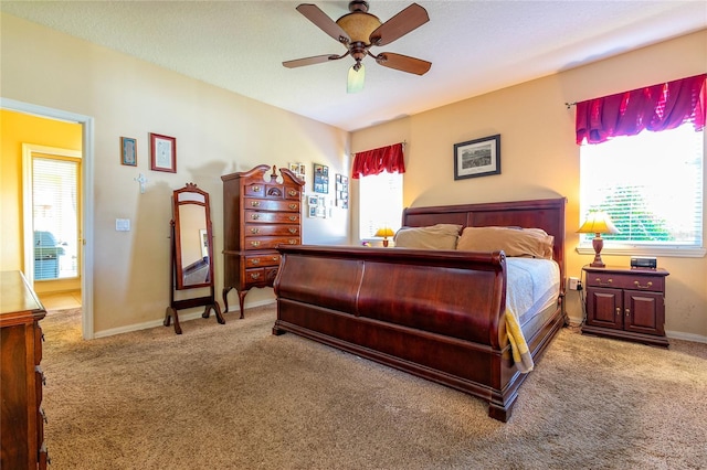 carpeted bedroom with baseboards and a ceiling fan