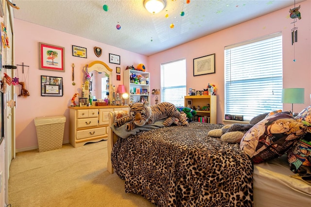 bedroom with light carpet and a textured ceiling