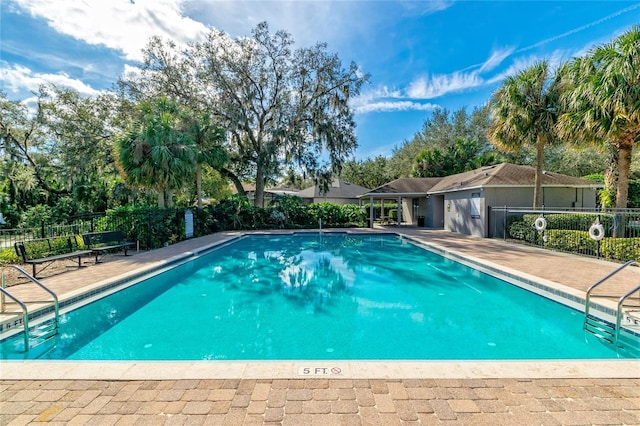 community pool featuring a patio and fence