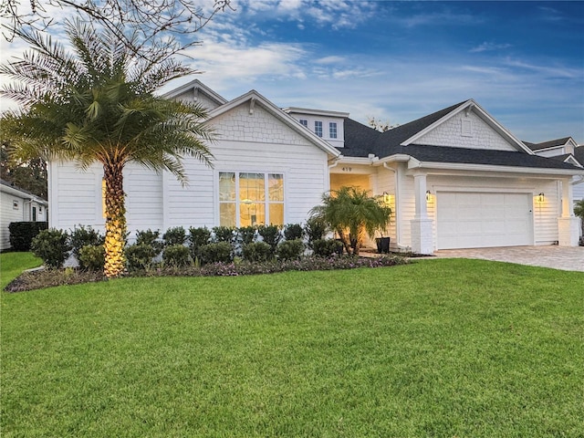 view of front of property with a garage and a front lawn