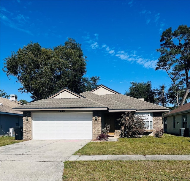 single story home featuring cooling unit, a garage, and a front lawn