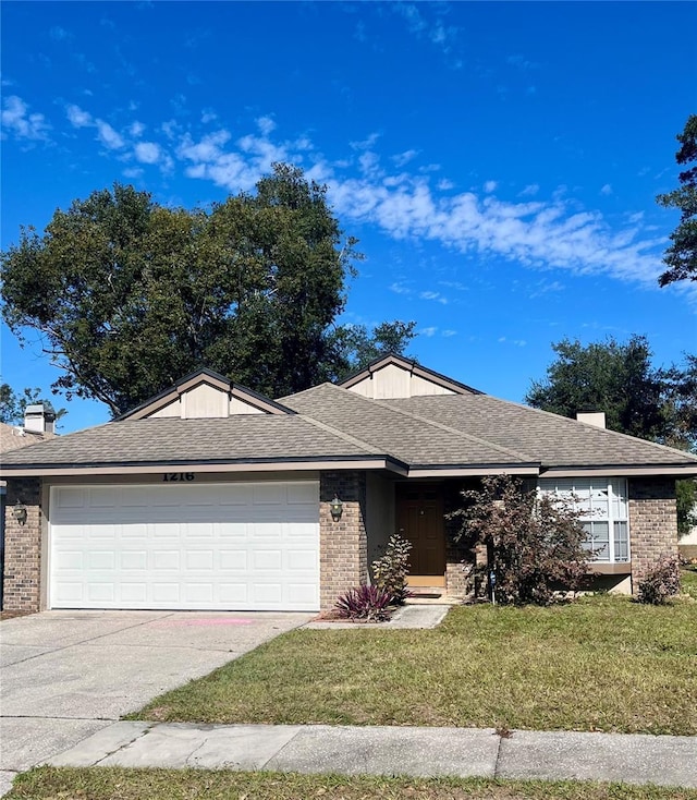 ranch-style house featuring a garage and a front yard