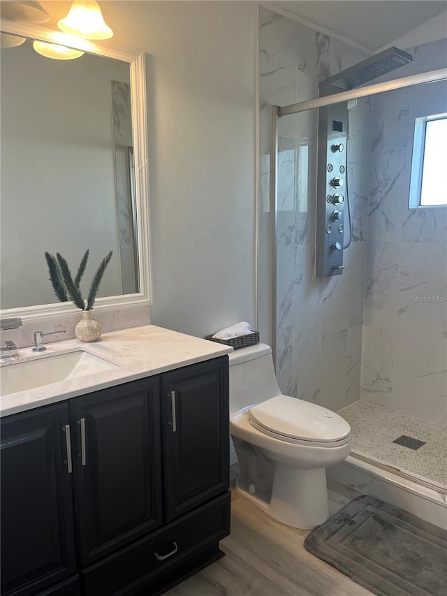 bathroom with vanity, toilet, a shower with door, and wood-type flooring