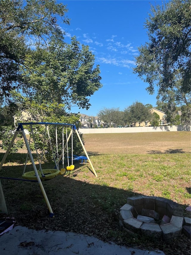 view of yard featuring a fire pit and a playground