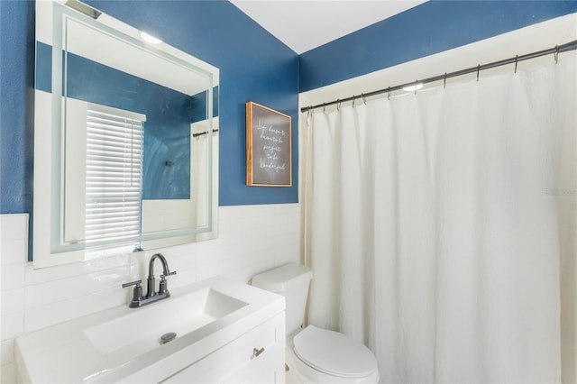 bathroom with vanity, backsplash, and toilet