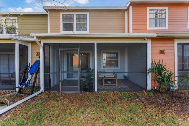 back of house with a sunroom and a patio