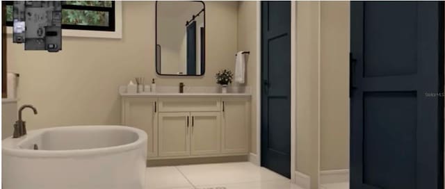 bathroom featuring vanity, a tub, and tile patterned floors