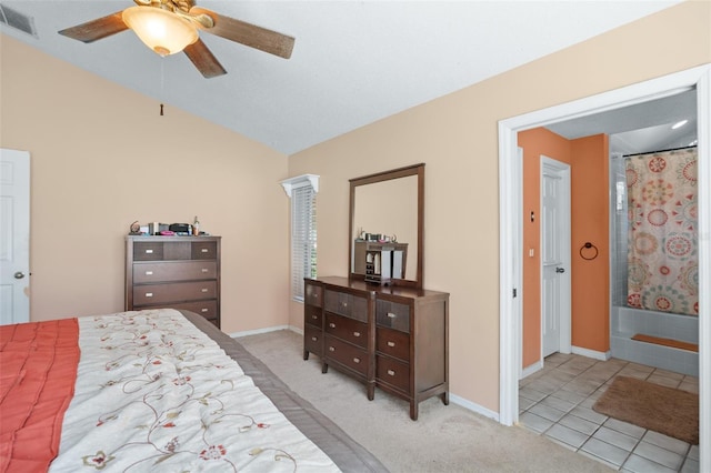 tiled bedroom featuring ensuite bath and ceiling fan