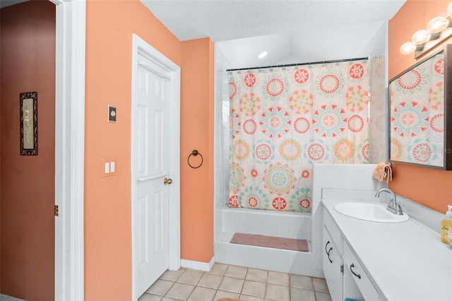 bathroom with tile patterned flooring, vanity, a textured ceiling, and a shower with shower curtain