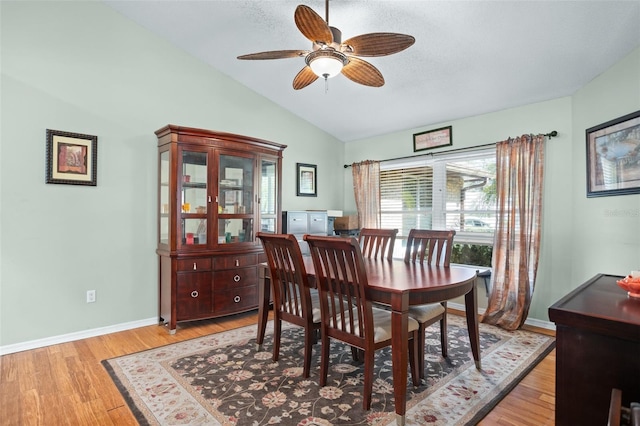 dining room featuring lofted ceiling, ceiling fan, and light hardwood / wood-style flooring