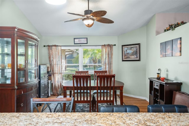 dining space featuring lofted ceiling, hardwood / wood-style floors, and ceiling fan