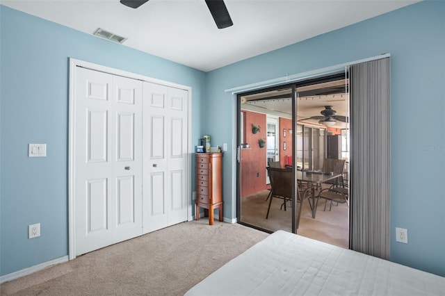 carpeted bedroom featuring ceiling fan and a closet