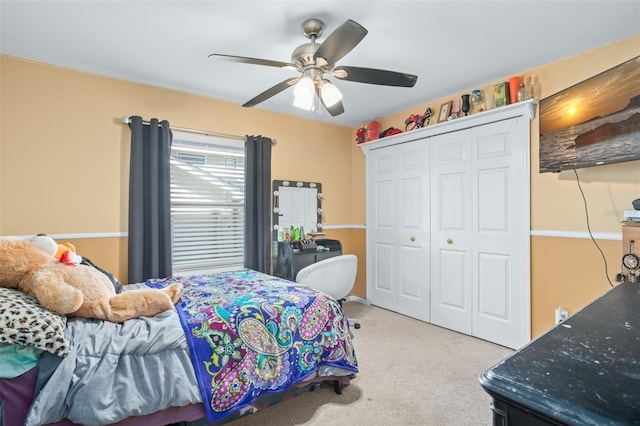 carpeted bedroom featuring ceiling fan and a closet