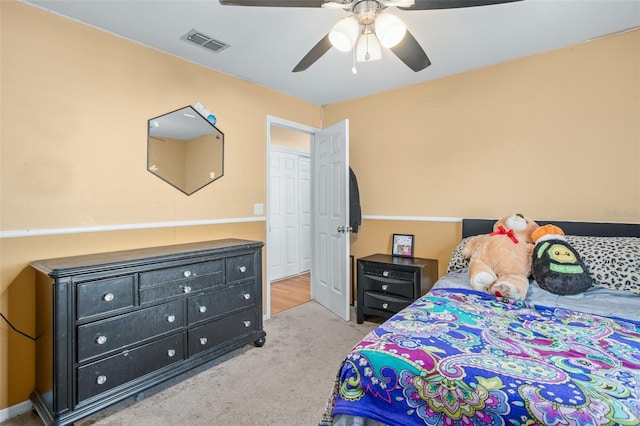 bedroom featuring light carpet and ceiling fan