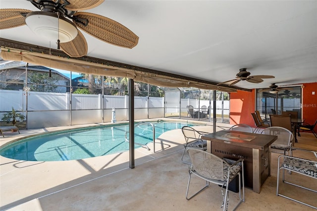 view of swimming pool with a lanai, ceiling fan, and a patio area