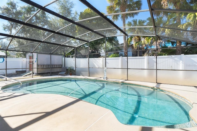 view of swimming pool with a patio and glass enclosure