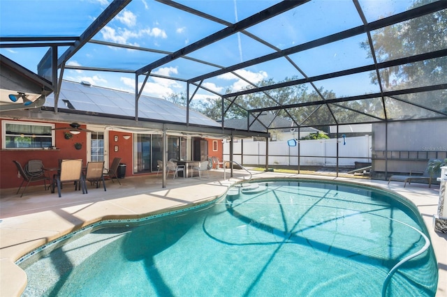 view of swimming pool with a lanai and a patio area