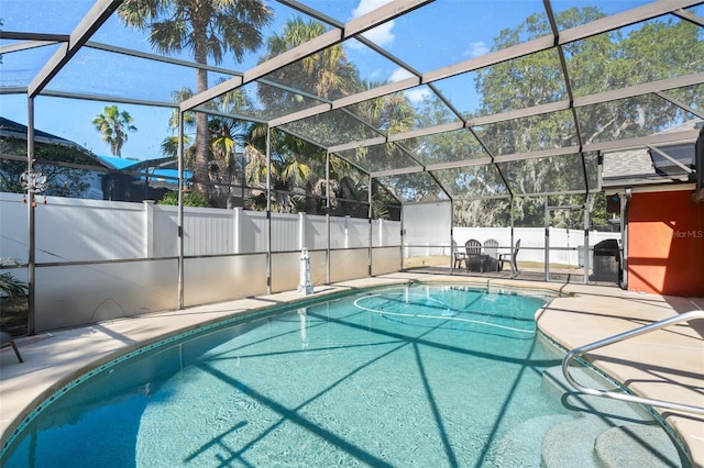 view of swimming pool with a lanai and a patio area