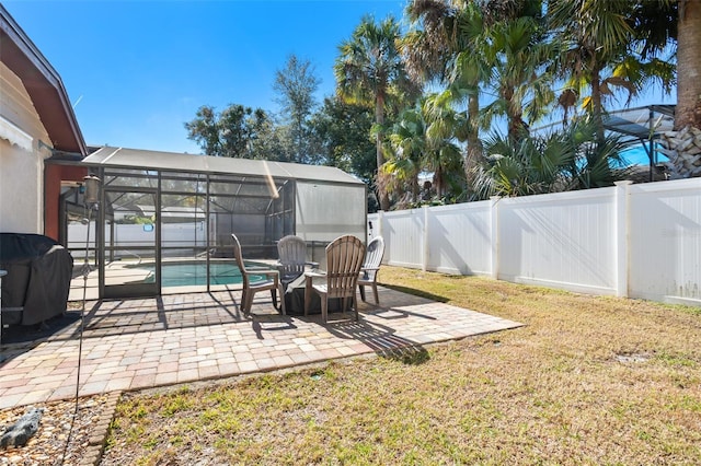 view of yard with a fenced in pool, a patio area, and glass enclosure