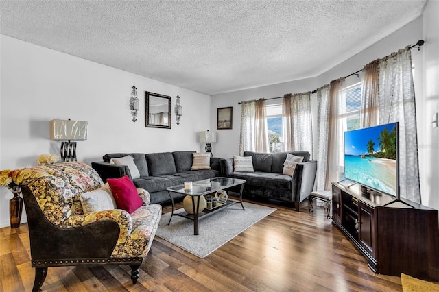 living room with dark hardwood / wood-style floors and a textured ceiling