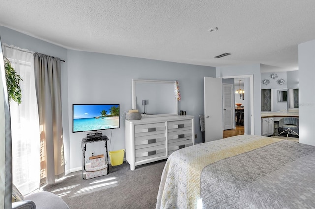 carpeted bedroom with a textured ceiling