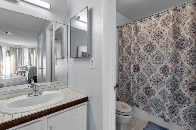 bathroom featuring vanity, a shower with curtain, and toilet