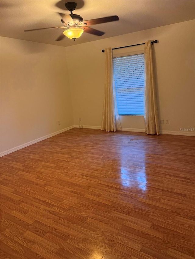 unfurnished room with ceiling fan and wood-type flooring