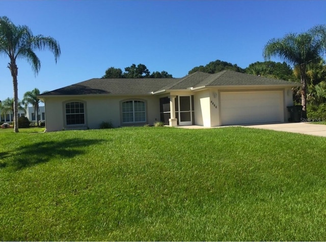 single story home featuring a garage and a front lawn