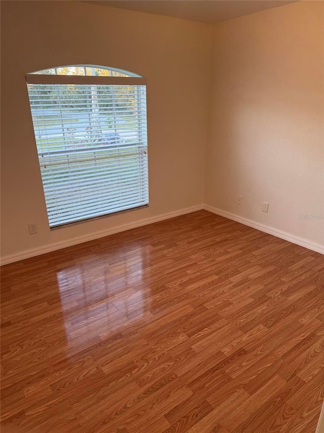 unfurnished room with hardwood / wood-style floors