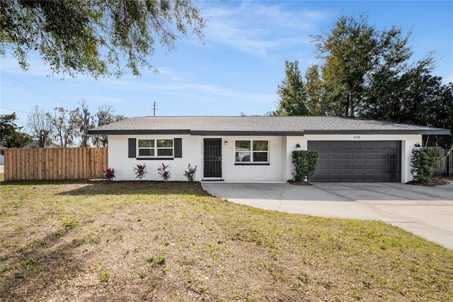 ranch-style house with a garage and a front yard