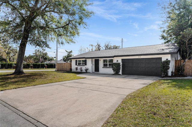 ranch-style house featuring a garage and a front yard