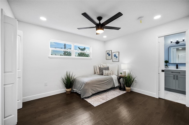 bedroom featuring dark hardwood / wood-style floors, ceiling fan, and ensuite bathroom