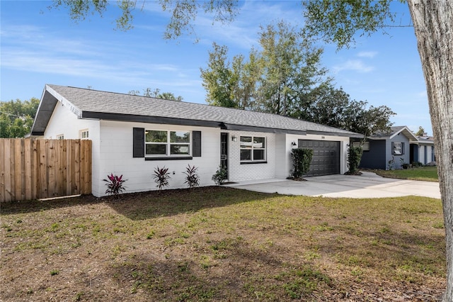 single story home featuring a garage and a front yard