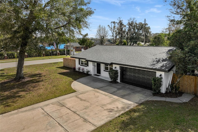 ranch-style home featuring a garage and a front lawn