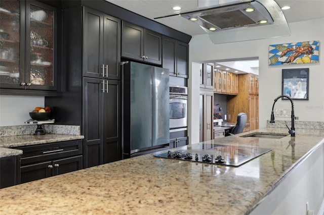 kitchen featuring stainless steel appliances, sink, light stone counters, and ventilation hood