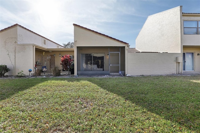 rear view of house featuring a yard